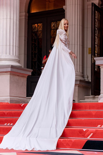 White dress with shoulder pads and cape