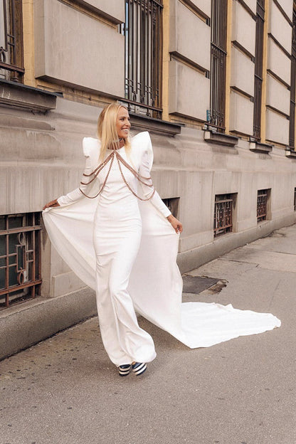 White dress with shoulder pads and cape